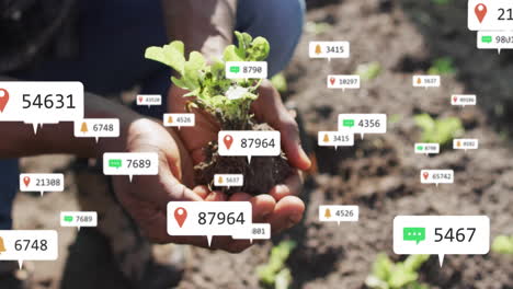 gardener holding seedling in soil, showing technology chat bubbles and notification bells floating