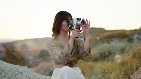 woman making a movie with vintage camera