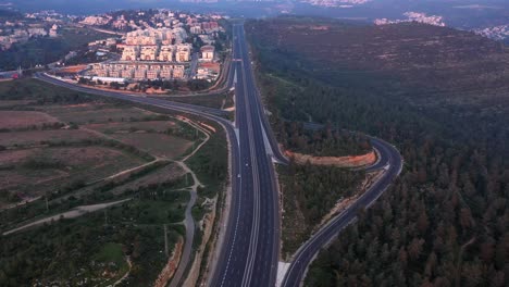 aerial view of a highway interchange near a residential town and forest