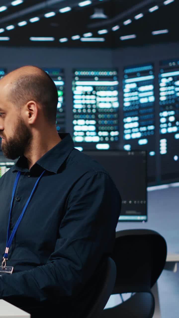 Focused IT Engineer Typing on Keyboard in Server Room