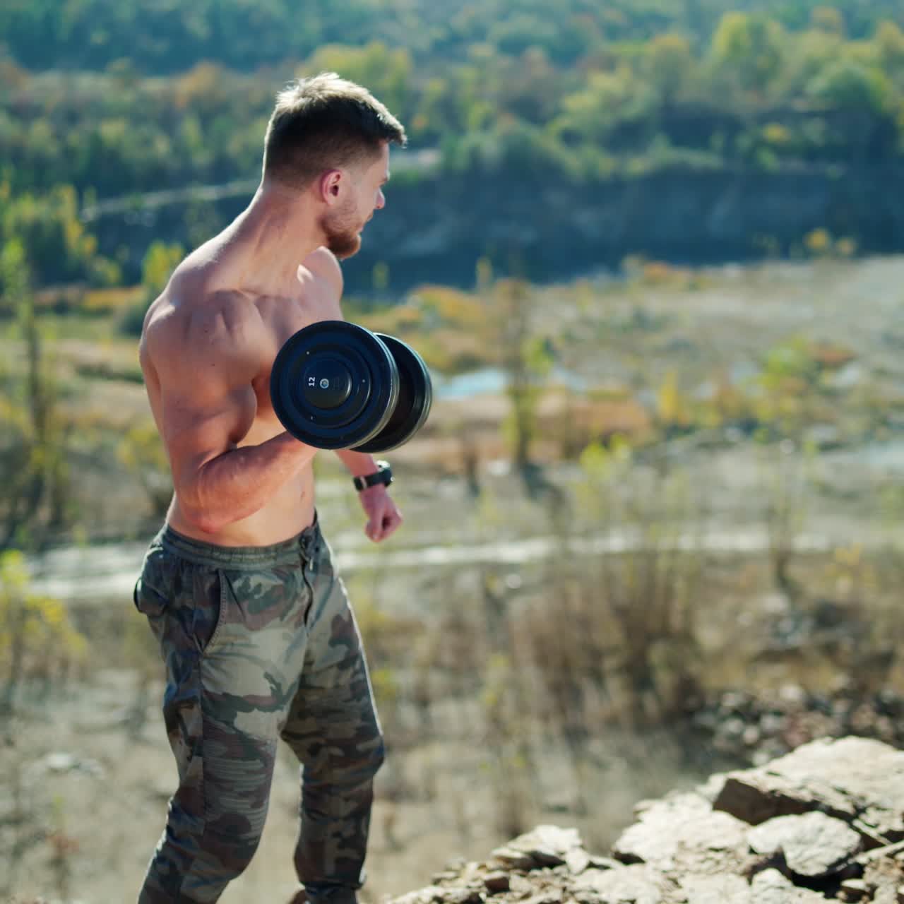 . Athletic sportsman weightlifting. Handsome muscular shirtless man lifting dumbbells