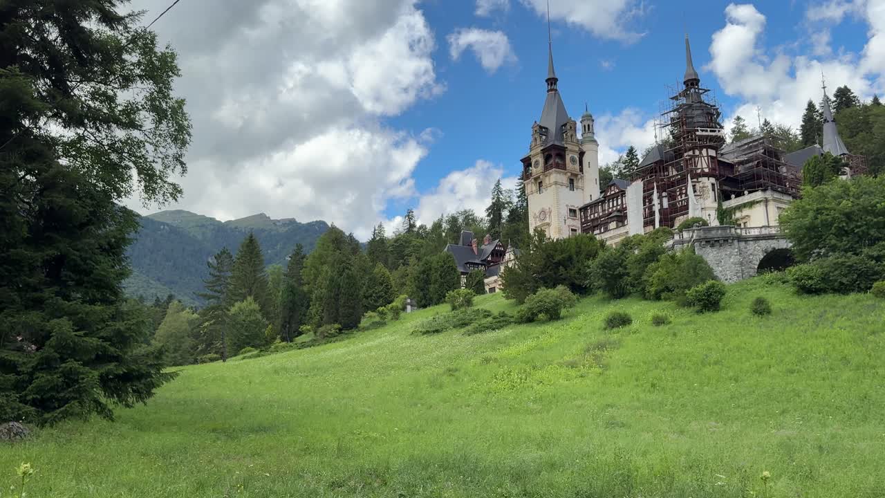 Picturesque Peles Castle in a rural valley of Transylvania. Panning