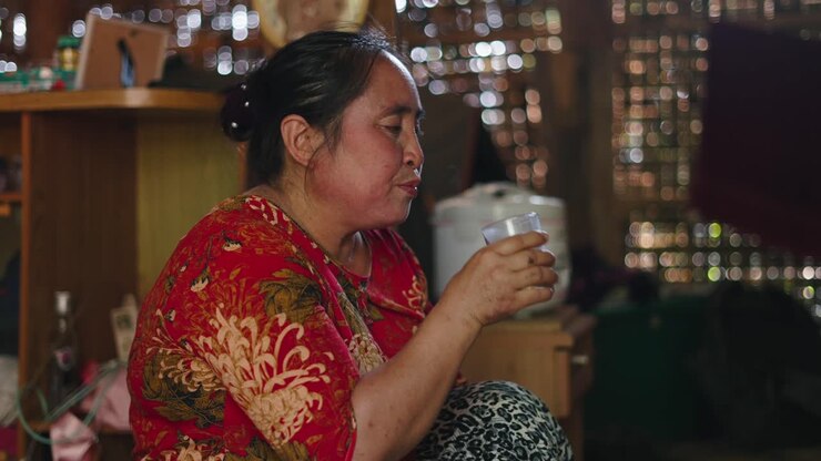 Woman drinking from a glass indoors