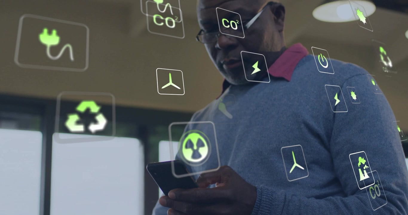 Animation of ecology icons over senior african american man using smartphone at home