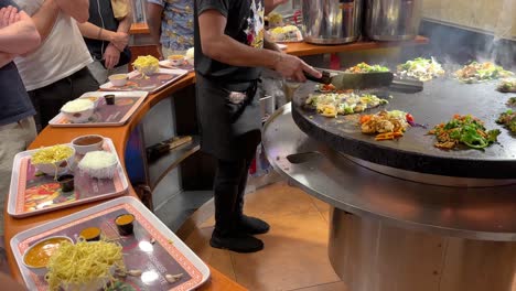 people are watching and waiting to get their food orders in a thai food restaurant