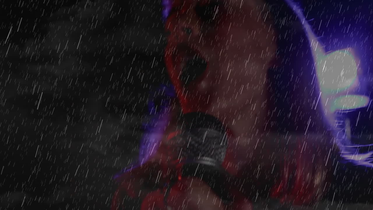 Female singer performing with microphone under heavy rain in entertainment, showing colorful lights