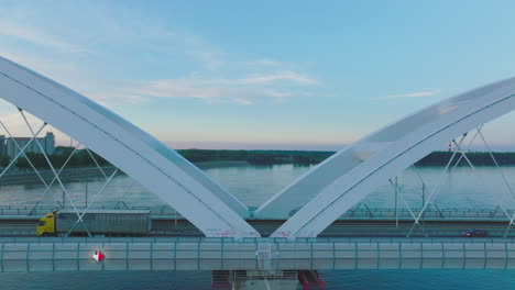 modern bridge over a river at sunset