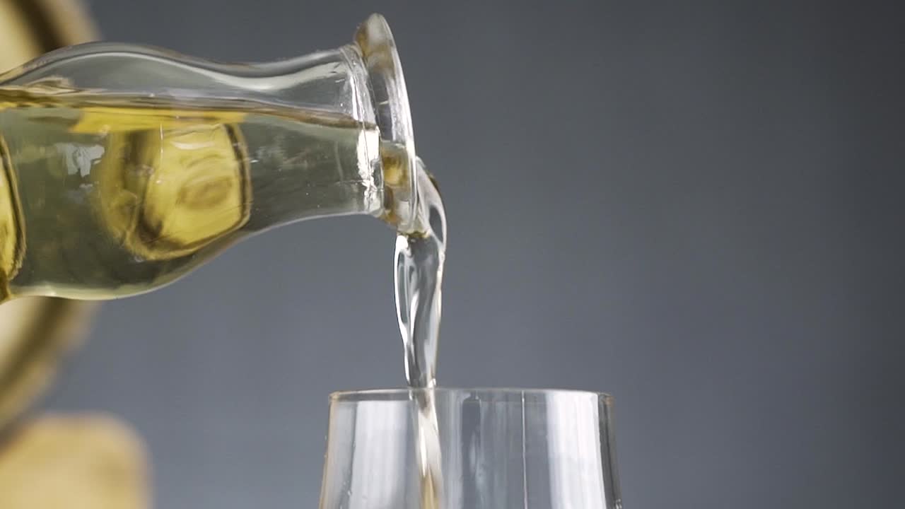 Close up of large amount of whisky being poured into glass