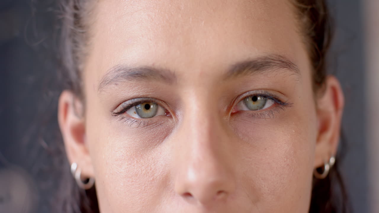 Close-up of woman's face with focused eyes, showing determination and strength