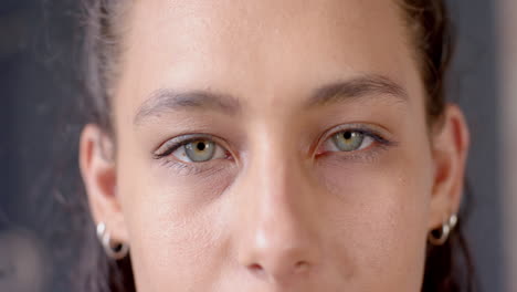 close-up of woman's face with focused eyes, showing determination and strength