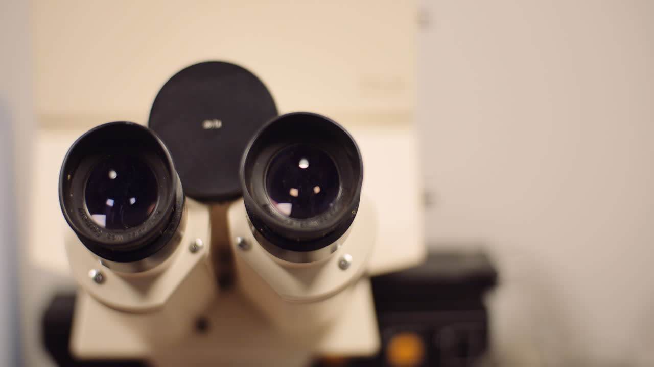 primer plano panorámico de microscopio óptico binocular en laboratorio