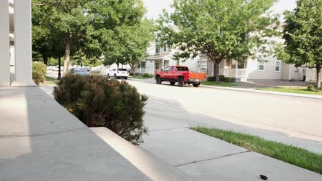 young man walking around the neighborhood and entering house by stepping on front porch steps