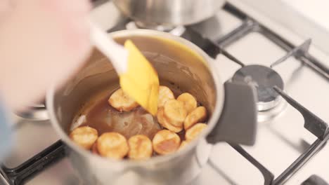 Close-up-scene-of-a-woman-who-is-making-a-cream-for-a-cake-from-bananas-in-melted-chocolate