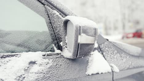 grey car coated ice crust and frost in cold weather during winter