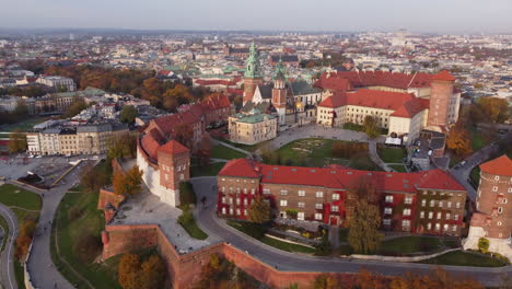 aerial flying towards wawel royal castle in golden hour, krakow