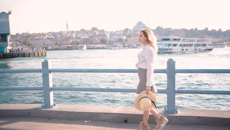 Slow-Motion:Beautiful-girl-stands-over-Galata-Bridge-and-enjoys-view-of-bosphorus-in-Istanbul,Turkey