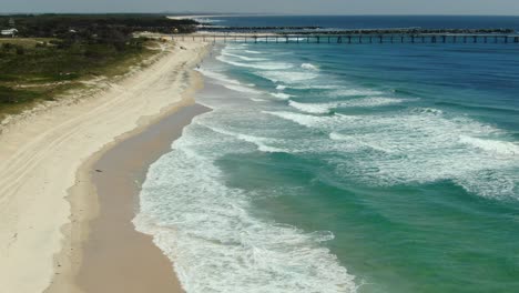 flying towards the gold coast seaway , golden beaches and waves rolling in