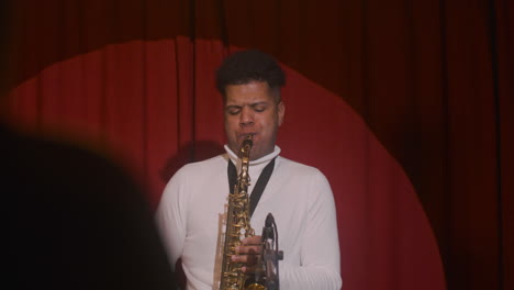 latin man playing sax during live music perfomance 3