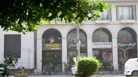 street view of commercial buildings in pakistan featuring ranchers, gloria jean's, shaheen chemist, and pizza hut