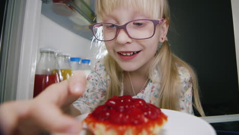 a little girl secretly tastes the cake in the fridge 1