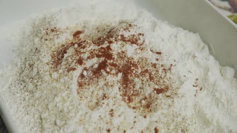 adding spice into cooking flour