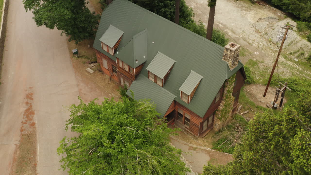 Drone ascending flyover view of a public accommodation cabin recreational area inside Plumas National Forest in California.