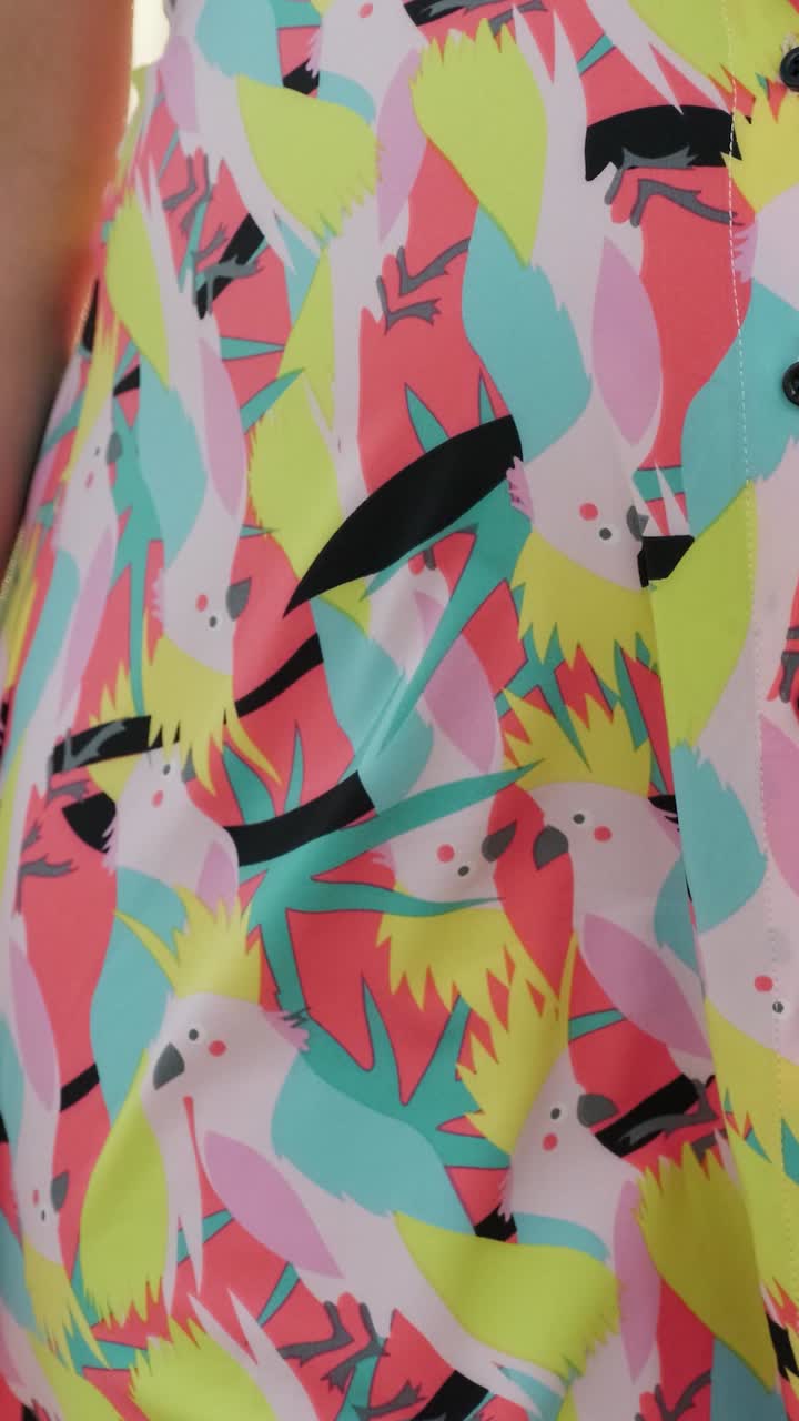 Close up of a dress with a cockatoo pattern