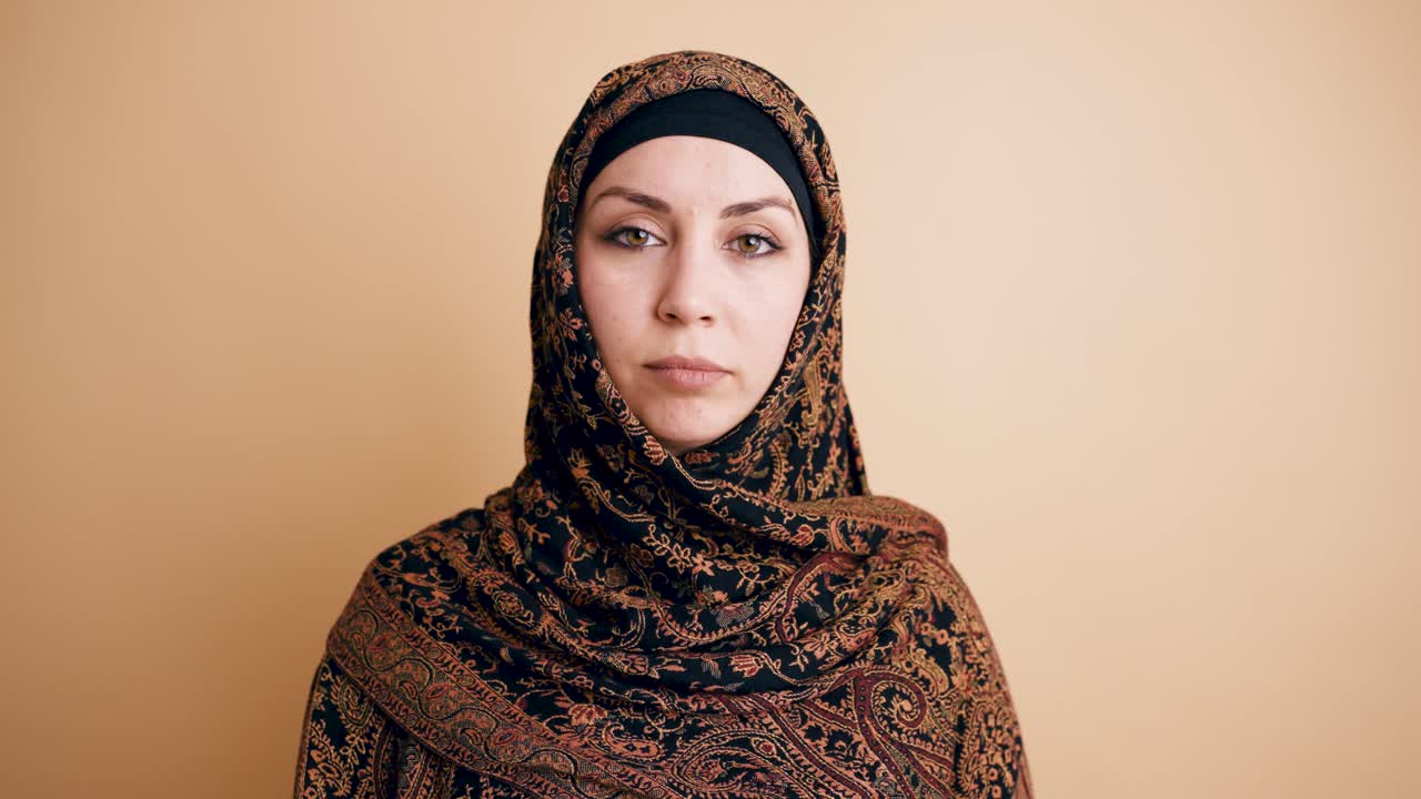Muslim Woman in Hijab Looking at Camera with Neutral Expression