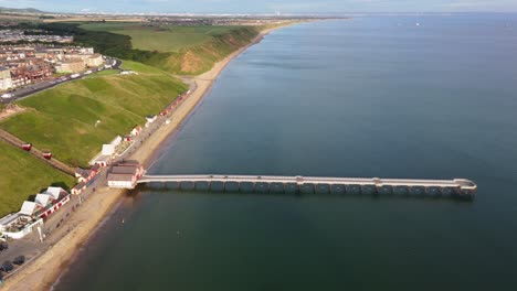 aerial drone view of saltburn-by-the-sea, saltburn pier and ocean in cleveland, north yorkshire in summer, early morning