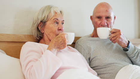 Senior,-man-and-woman-with-coffee-in-bedroom
