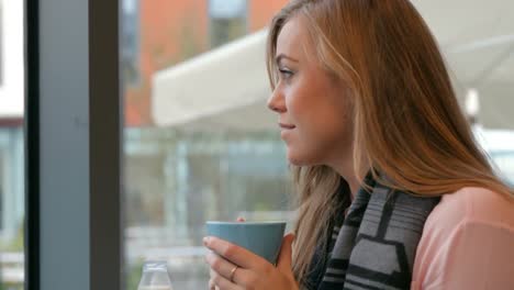 pretty blonde enjoying coffee in cafe