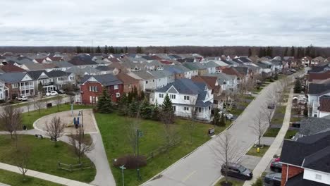 drone circling over ajax neighborhood near a lake in the winter