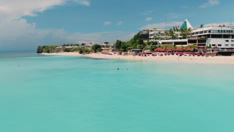 dreamland beach bali from above, aerial 4k footage. azure water and punch colors, white sand beach.