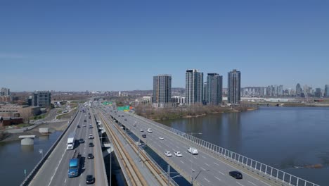 aerial view of highway and cityscape over river in montreal