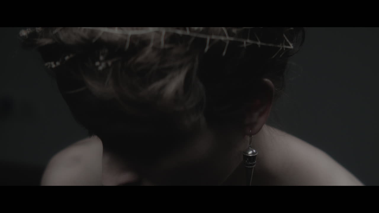 A woman dressed as mother nature shows her hair