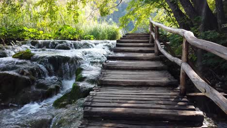 moving up some wooden stairs along a series of waterfalls at plitvice lakes national park in croatia, europe