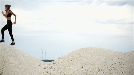 woman running in sand dunes