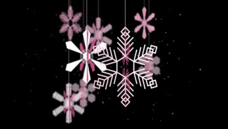 animation of christmas baubles and snow falling on black background