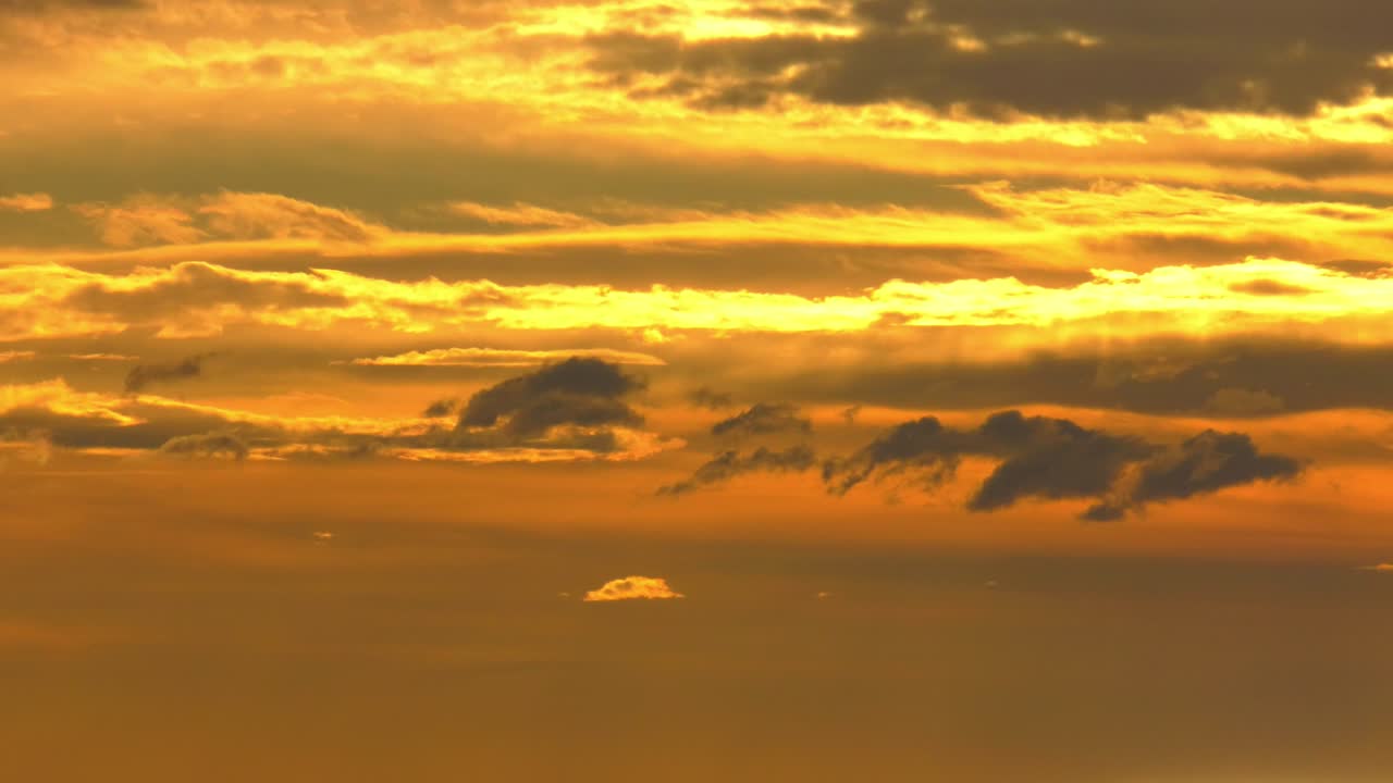 Dramatic time lapse of orange dawn skies with clouds moving