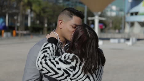 Beautiful-happy-couple-hugging-and-kissing-on-street