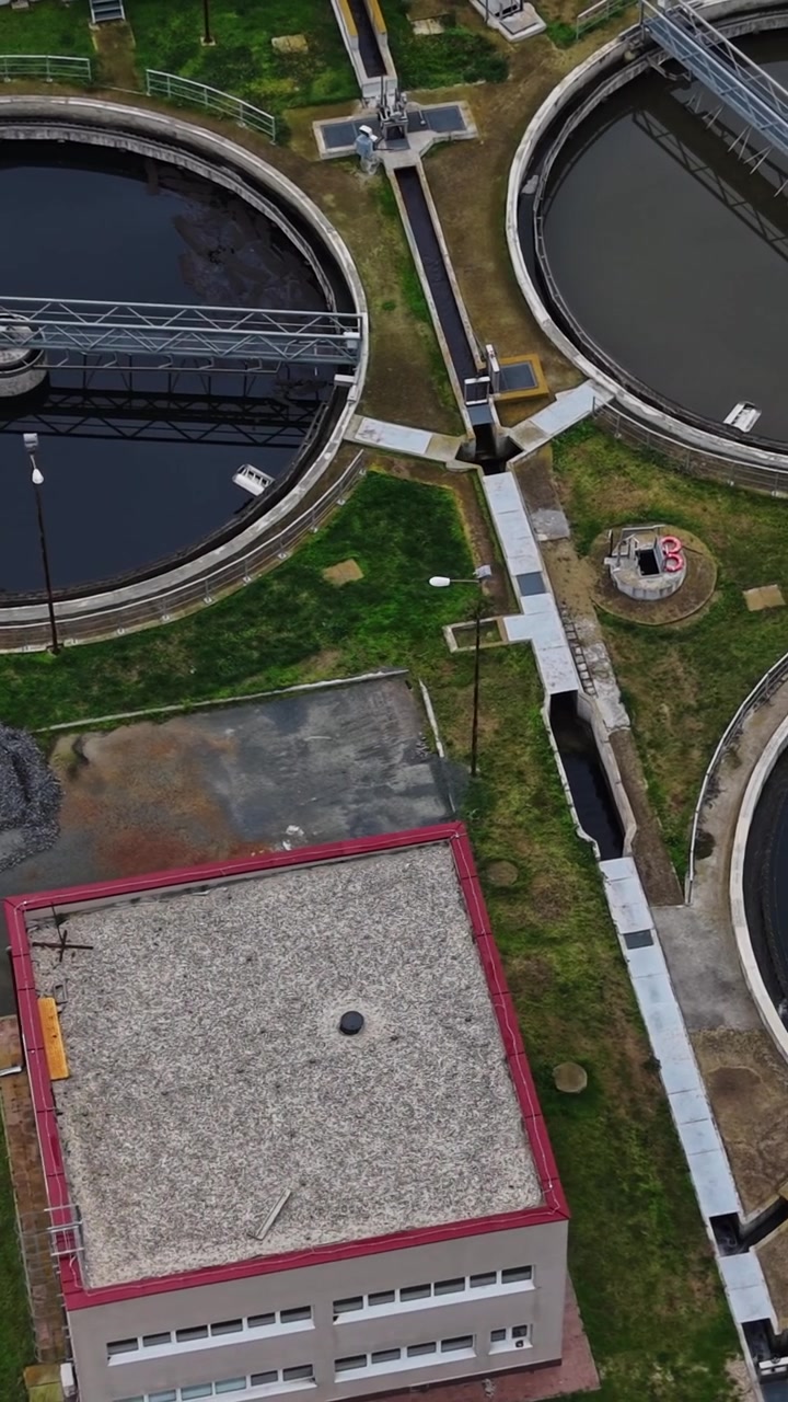 Water treatment facility shows tanks and pipes in processing area