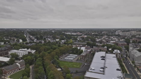 Trenton-New-Jersey-Aerial-v2-low-flyover-North-25-capturing-leafy-residential-neighborhood,-community-park-and-downtown-cityscape-under-an-overcast-sky---Shot-with-Mavic-3-Pro-Cine---September-2023