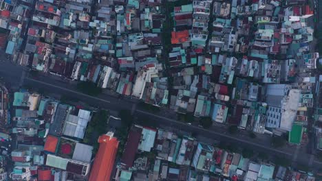 early morning top down drone view of streets and rooftops in a busy and densely populated area featuring main roads and church building
