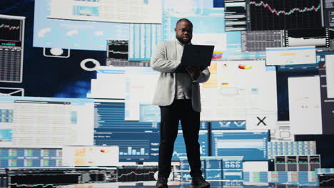 black professional administrator examining digital dashboard with finance graphs