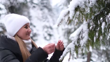 a charming young girl enjoys the new year holidays and the first snow in the forest girl walks in the woods in winter a charming young girl enjoys the new year holidays and the first snow in the forest