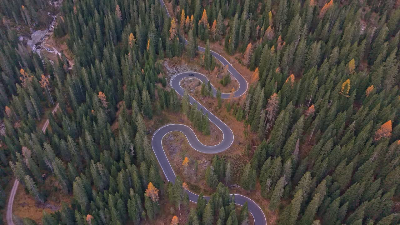 Drone view of famous Snake Road winding across autumn hills, Italy
