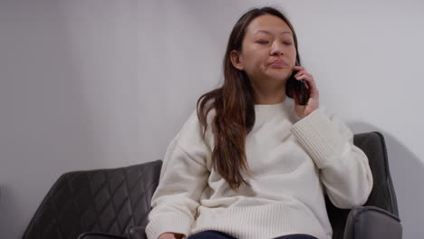 anxious or stressed woman taking call on mobile phone at work in office building 3