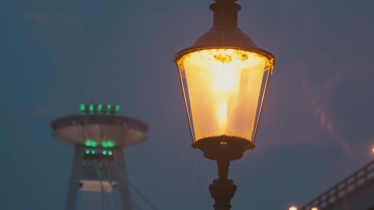 Detail of city lamp during rainy evening in front of ufo bridge in Bratislava.