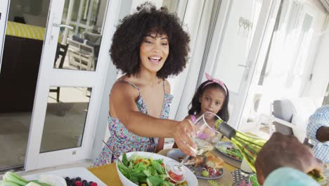 video of african american family spending time together and having dinner outside