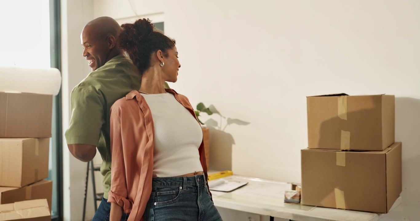 Happy Couple Dancing Together While Moving Into New Home